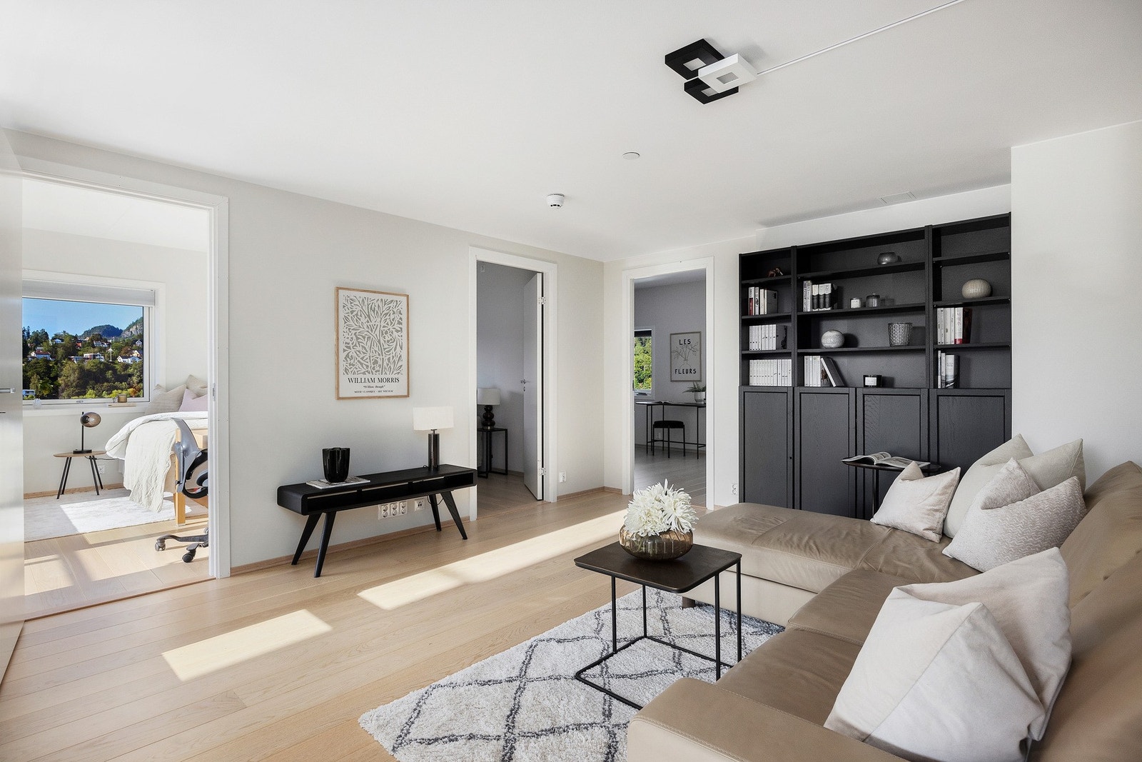 Inn fra entreen møtes man av hall/stue som knytter boligens ytterligere rom sammen Galleribilde