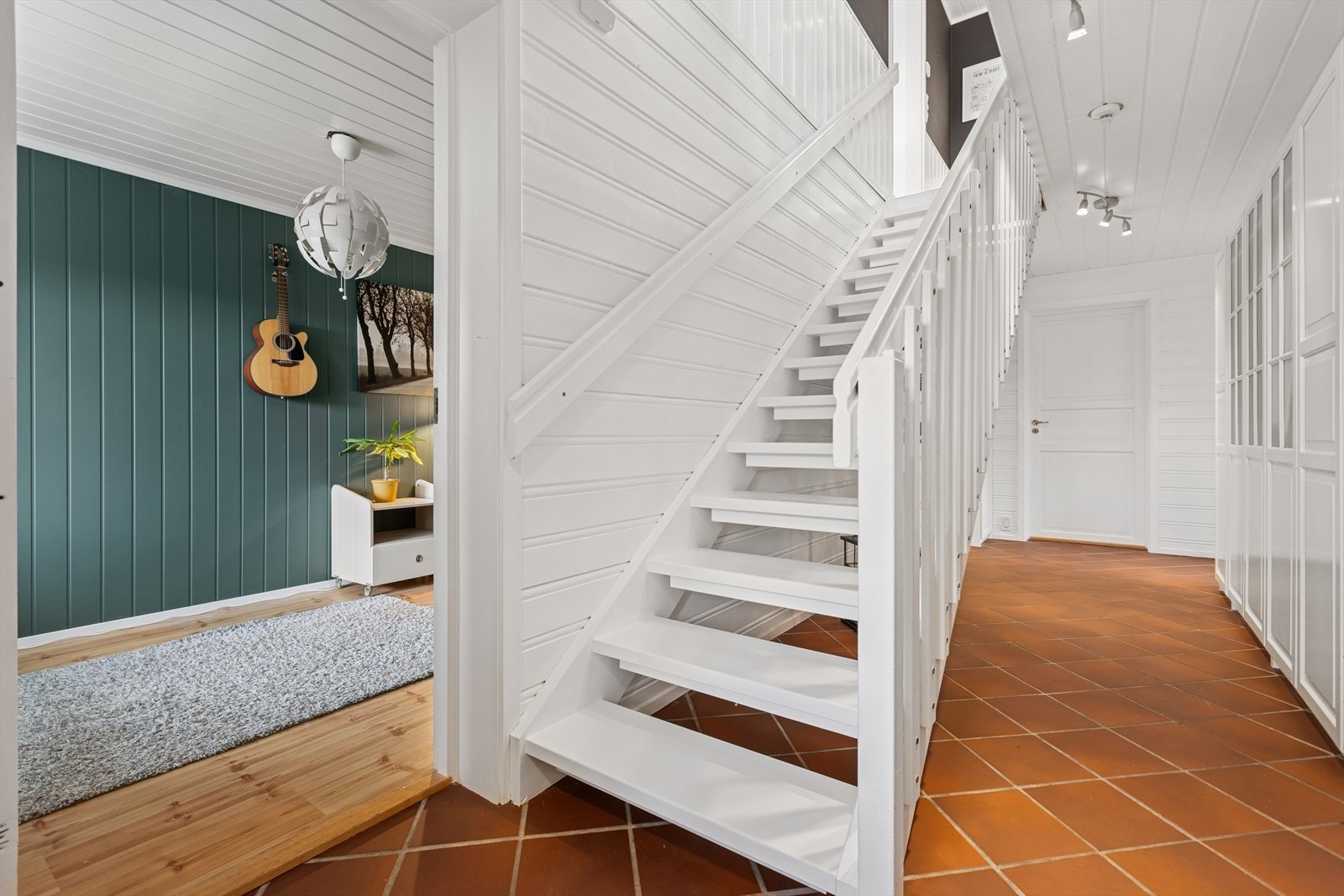 Entré/gang med lyse overflater og flislagt gulv. Galleribilde