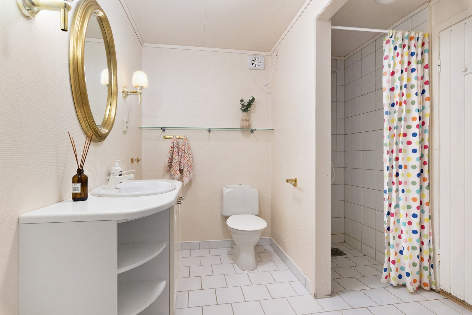 Du finner to bad i boligen, ett i hver etasje. Dette er badet i underetasjen og til høyre skimter du døren til saunaen. Galleribilde