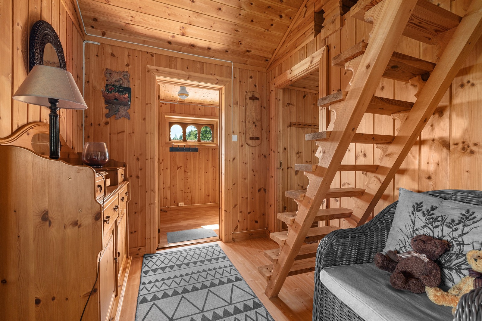 Innbydende gang med trepanel på vegger og tak, samt trapp til hems. Galleribilde