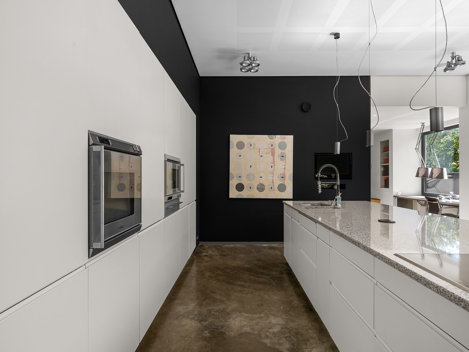 Tidløst design av høy kvalitet. Legg merke til granitt i ett helt stykke. Stikkontakt i benkeplate for arbeid med kjøkkenmaskiner. Multiform, med koketopp, stekeovn, dampovn og varmeskuff fra Gaggenau. Galleribilde