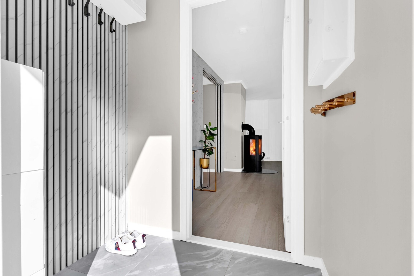 Når du trer inn i leiligheten møtes du av en lys og flislagt entré med elektrisk gulvvarme. Her er det plass til å henge fra seg yttertøy og sette skoene pent på plass. Galleribilde