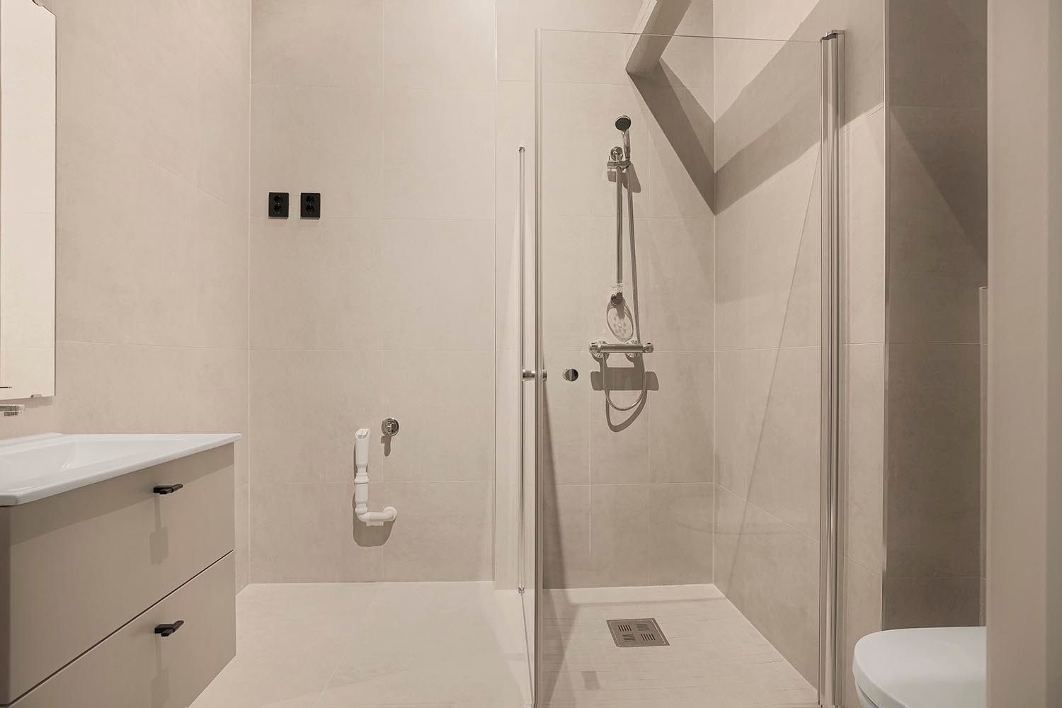 Bad 2 med toalett, servant, hjørnedusj og opplegg for vaskemaskin. Galleribilde