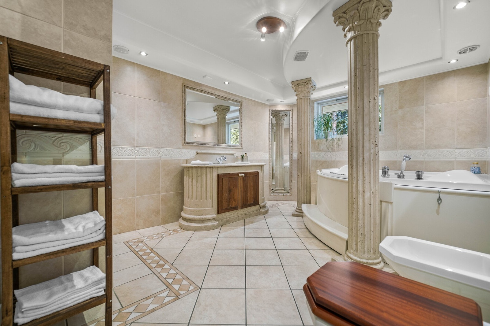 Varme er lagt i gulvet, og badet har toalett, bidé og nedsenket himling med downlights. Galleribilde