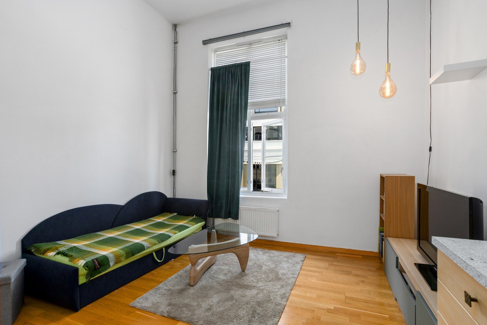 Stuen og kjøkkenet utgjør et åpent og sosialt allrom, med imponerende takhøyde og mye naturlig lys via en stor vindusflate i front. Galleribilde