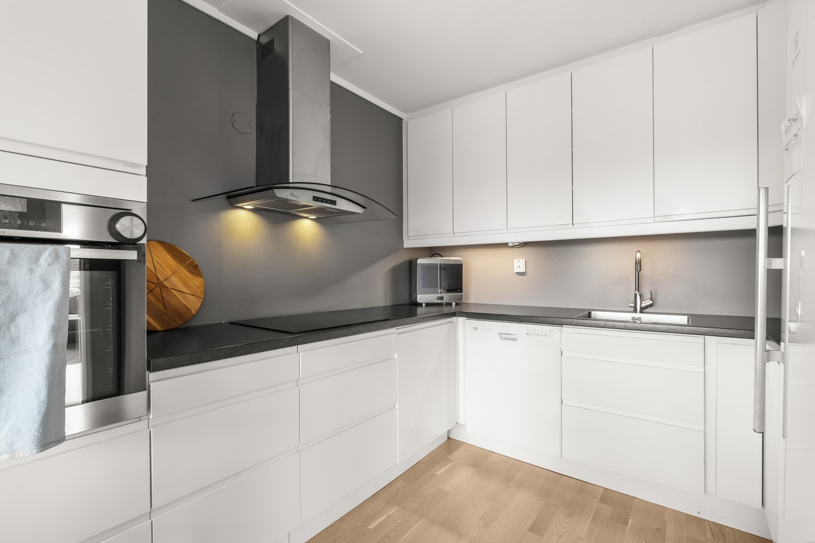 Kjøkkenet har en praktisk utforming med rikelig oppbevaringsplass og gode arbeidsflater, samtidig som det er plass til en koselig spiseplass ved vinduet. Galleribilde