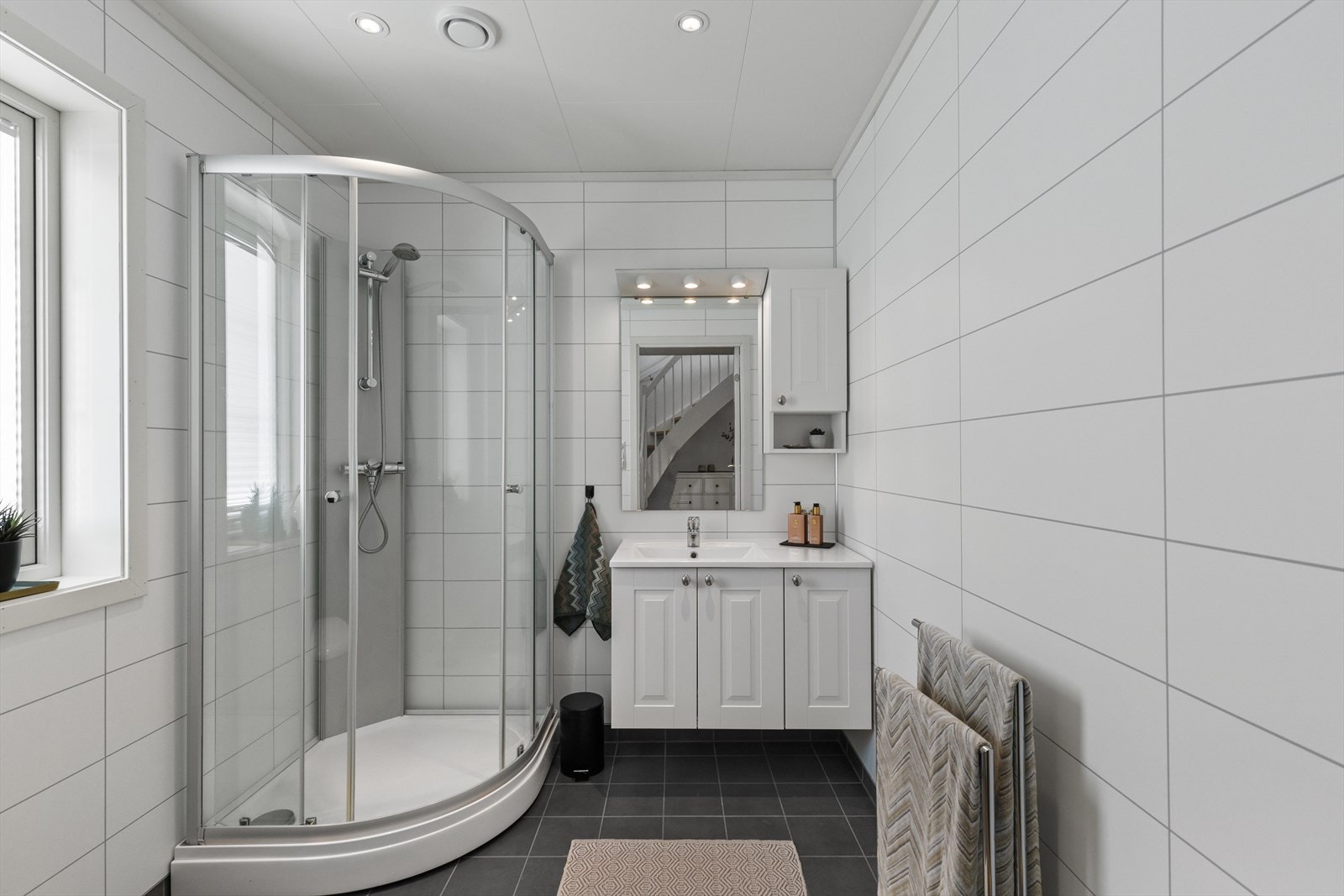 Moderne bad med flislagt gulv og baderomsplater på vegg. Galleribilde