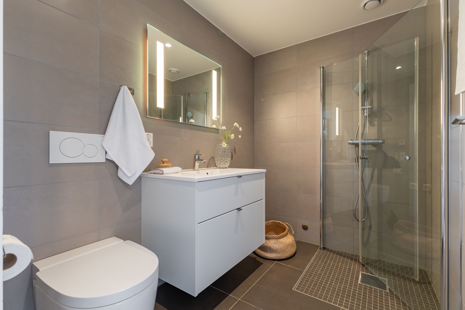 Badet har flislagte overflater med store fliser i moderne farge. Galleribilde