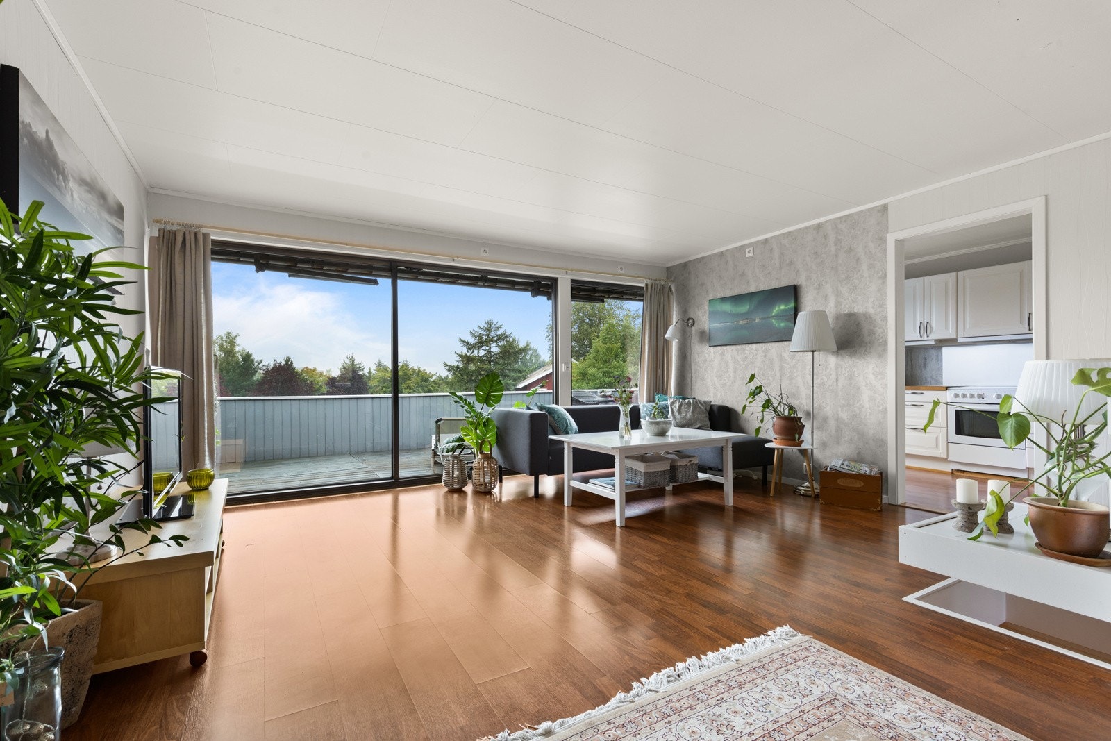 Gjennomgående og særdeles lys stue med vindusflater fra gulv til tak ut mot balkong. Galleribilde