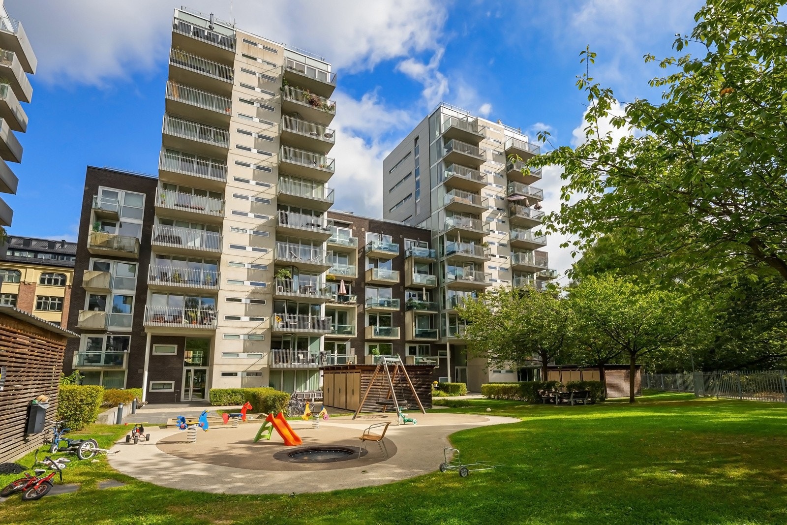 Fellesområdet er pent opparbeidet med lekeplasser, hyggelige sittegrupper og vakre japanske kirsebærtrær som står i full blomst i mai. Galleribilde