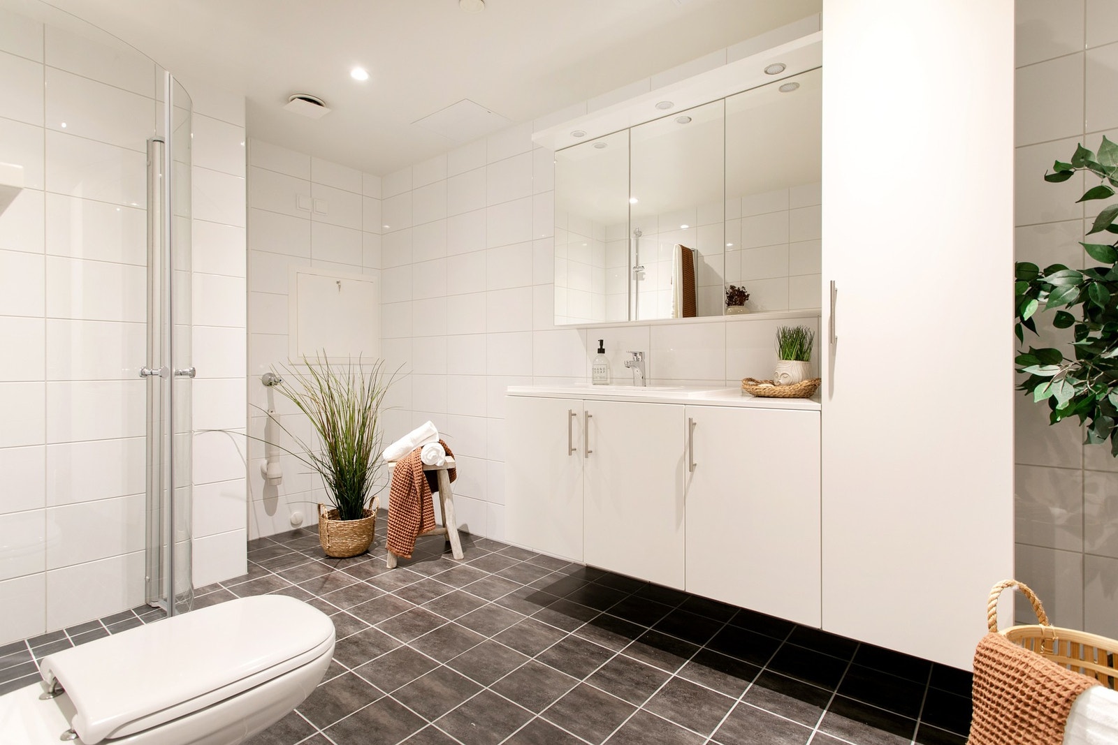 Pent flislagt bad med god lagringsplass i innredningen. NB: bildene er av tilsvarende leilighet i prosjektet som er identisk. Galleribilde