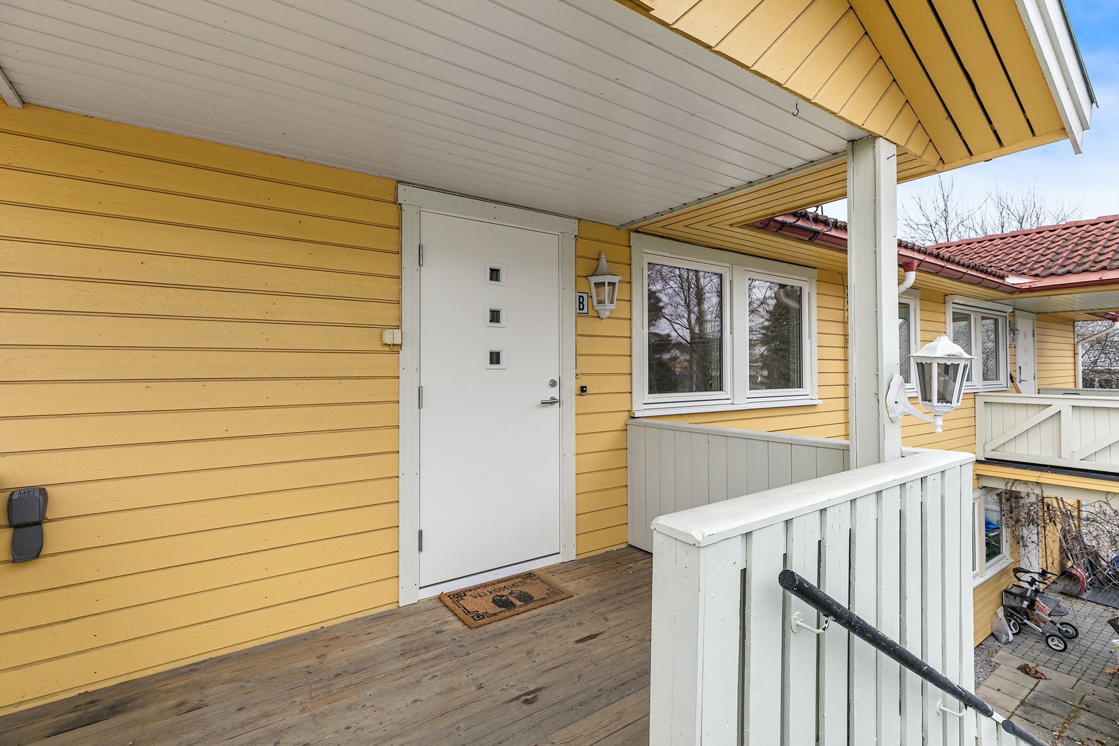 Overbygget inngangsparti med en liten balkong. Galleribilde