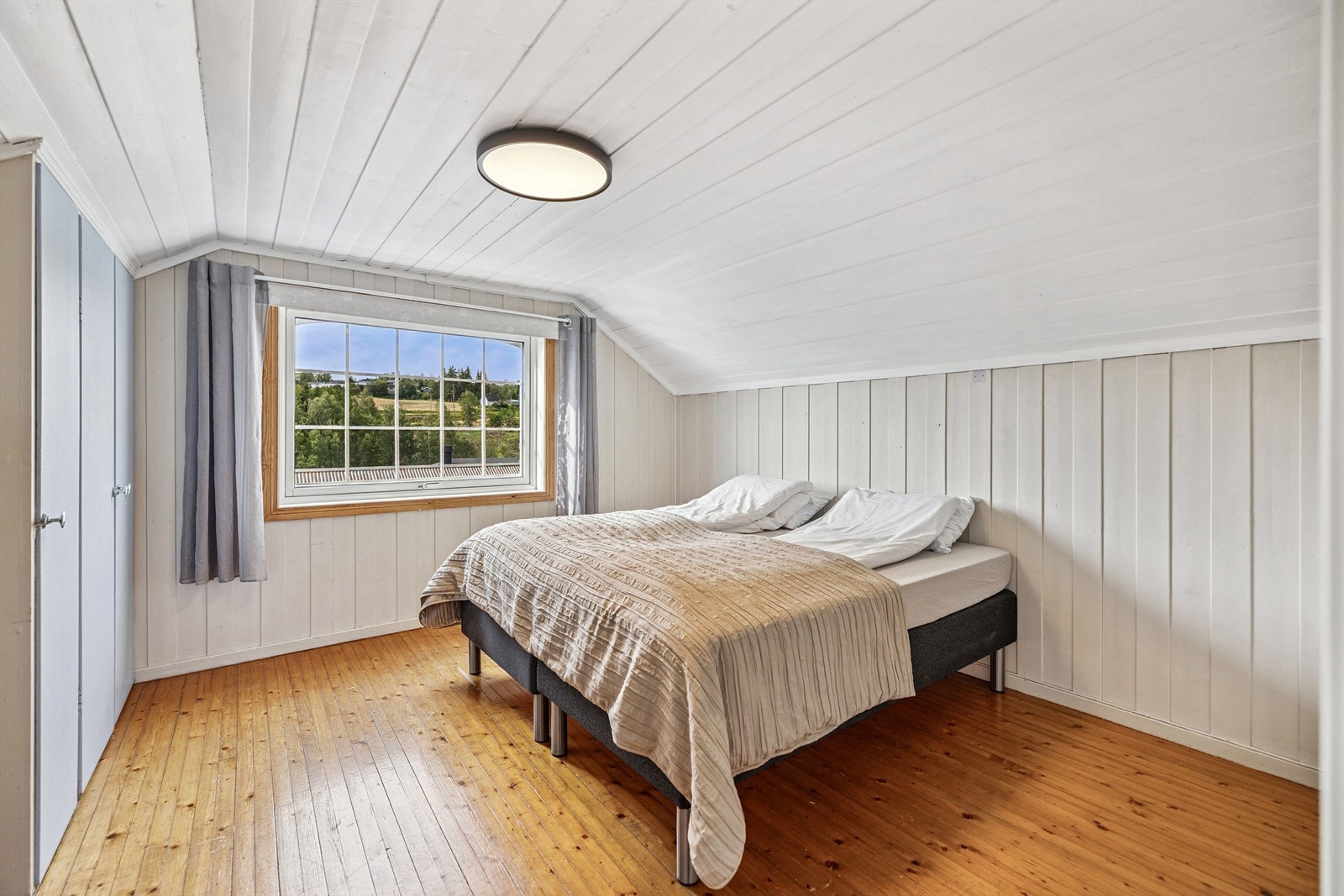 Lyst soverom med sjarmerende heltregulv og god plass til dobbeltseng. Galleribilde