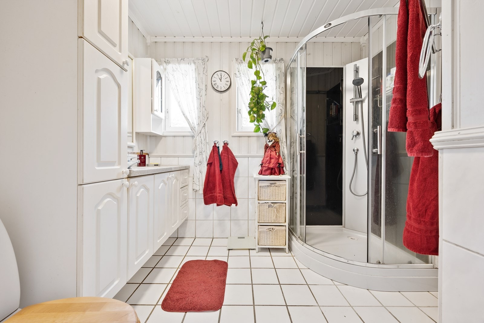 Badet er innredet med servantskap med profilerte fronter, toalett og dusjkabinett. Galleribilde