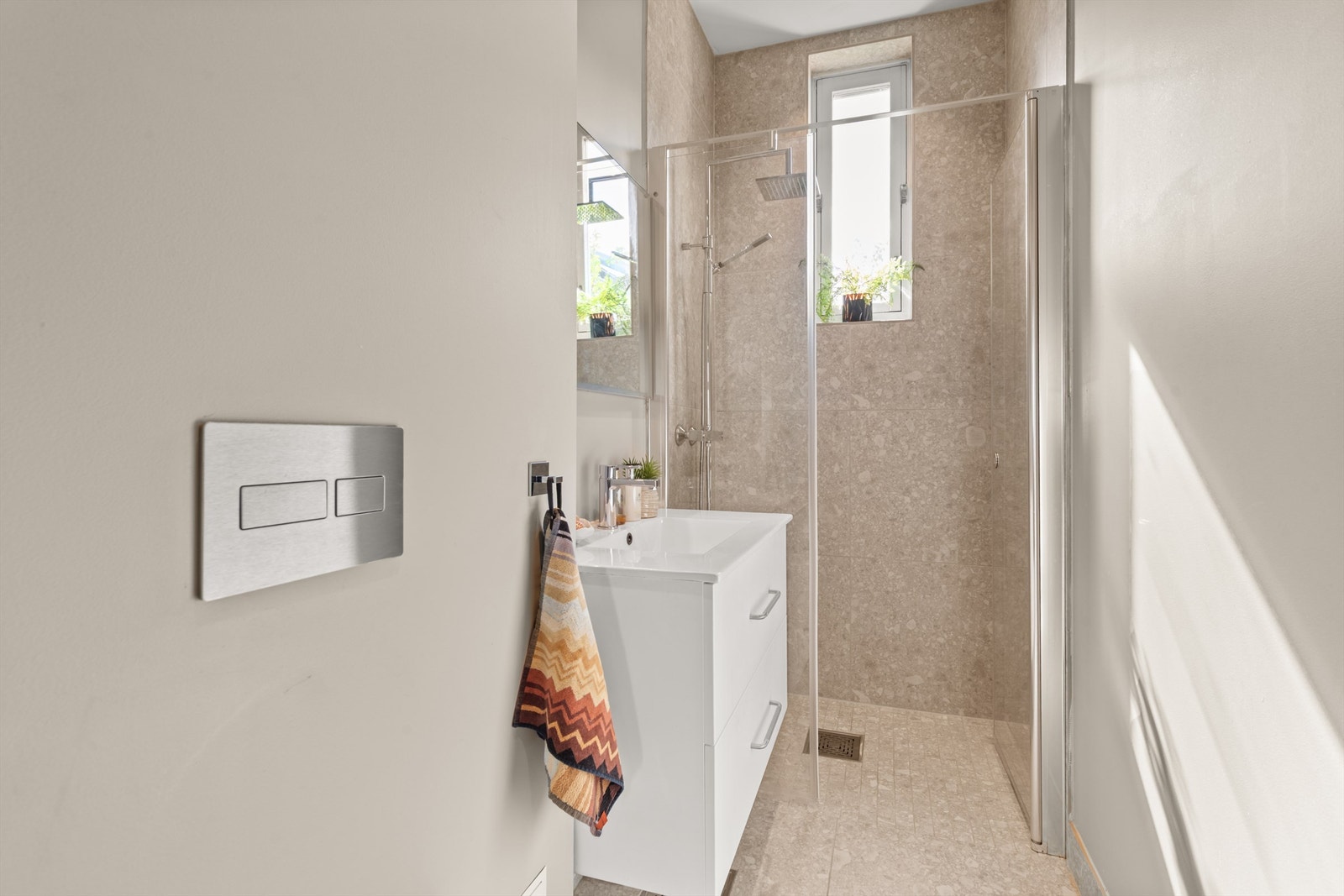 Badet er renovert i 2020 og har pent flislagte på gulv og vegger, med elektrisk varme i gulvet. Galleribilde