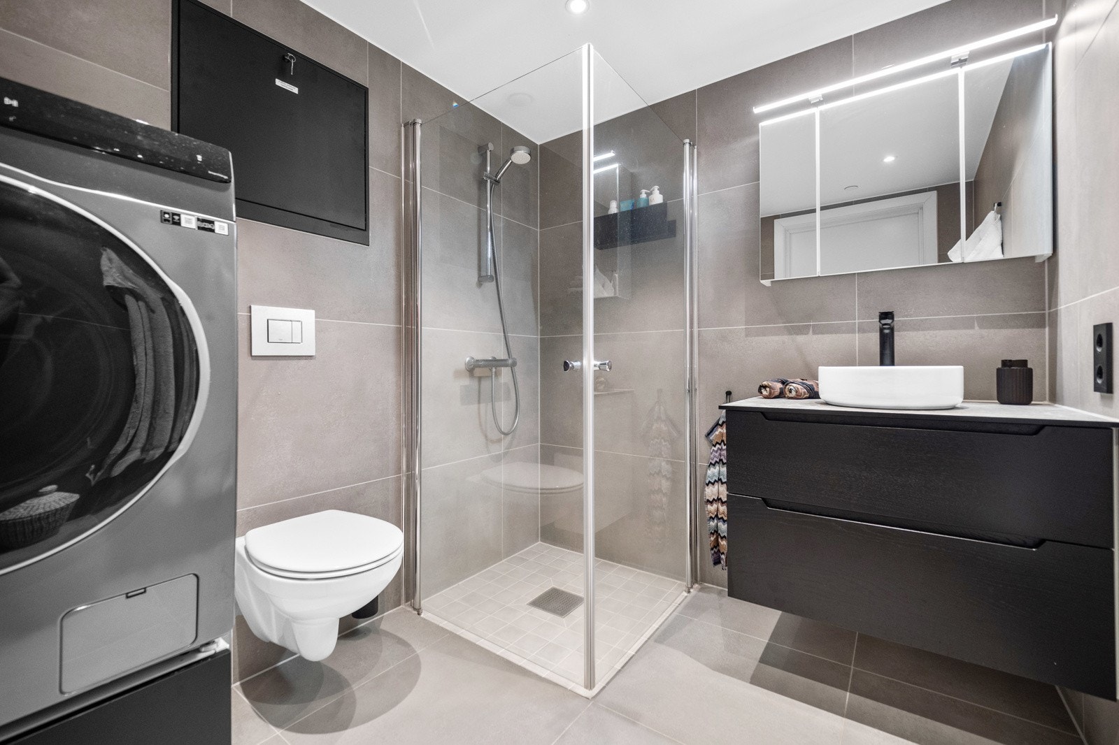 Lekkert helfliset bad av høy kvalitet. Her har man god plass til vaskemaskin/tørketrommel. Galleribilde