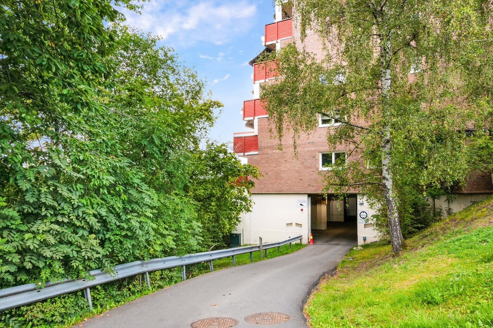 Innkjøring til garasjeanlegget med låsbar ytterdør og kameraovervåking. Galleribilde