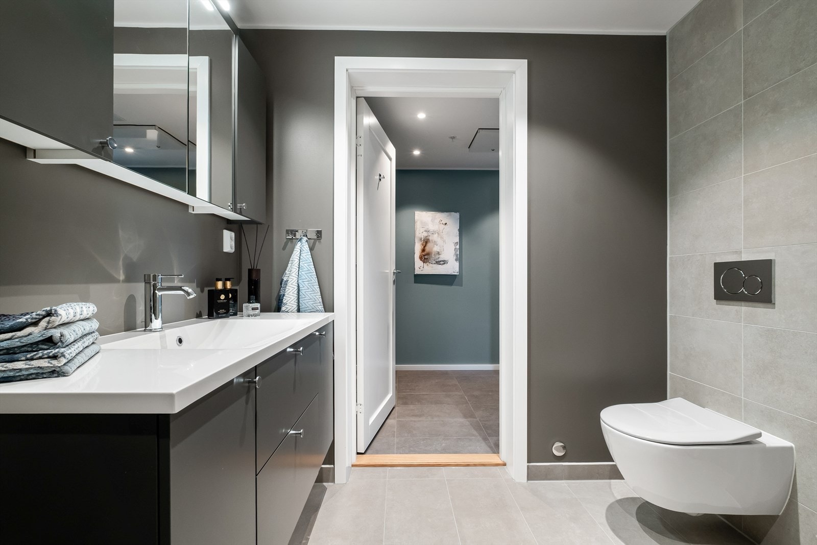 Det er utstyrt med flott baderomsinnredning, vegghengt toalett, dusjhjørne og opplegg for både vaskemaskin og tørketrommel Galleribilde