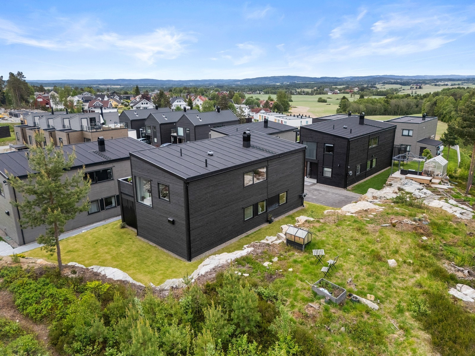 Eiendommen er pent opparbeidet med gressplen og asfaltert gårdsplass. Videre er det naturtomt rundt eiendommen som kan disponeres. Galleribilde