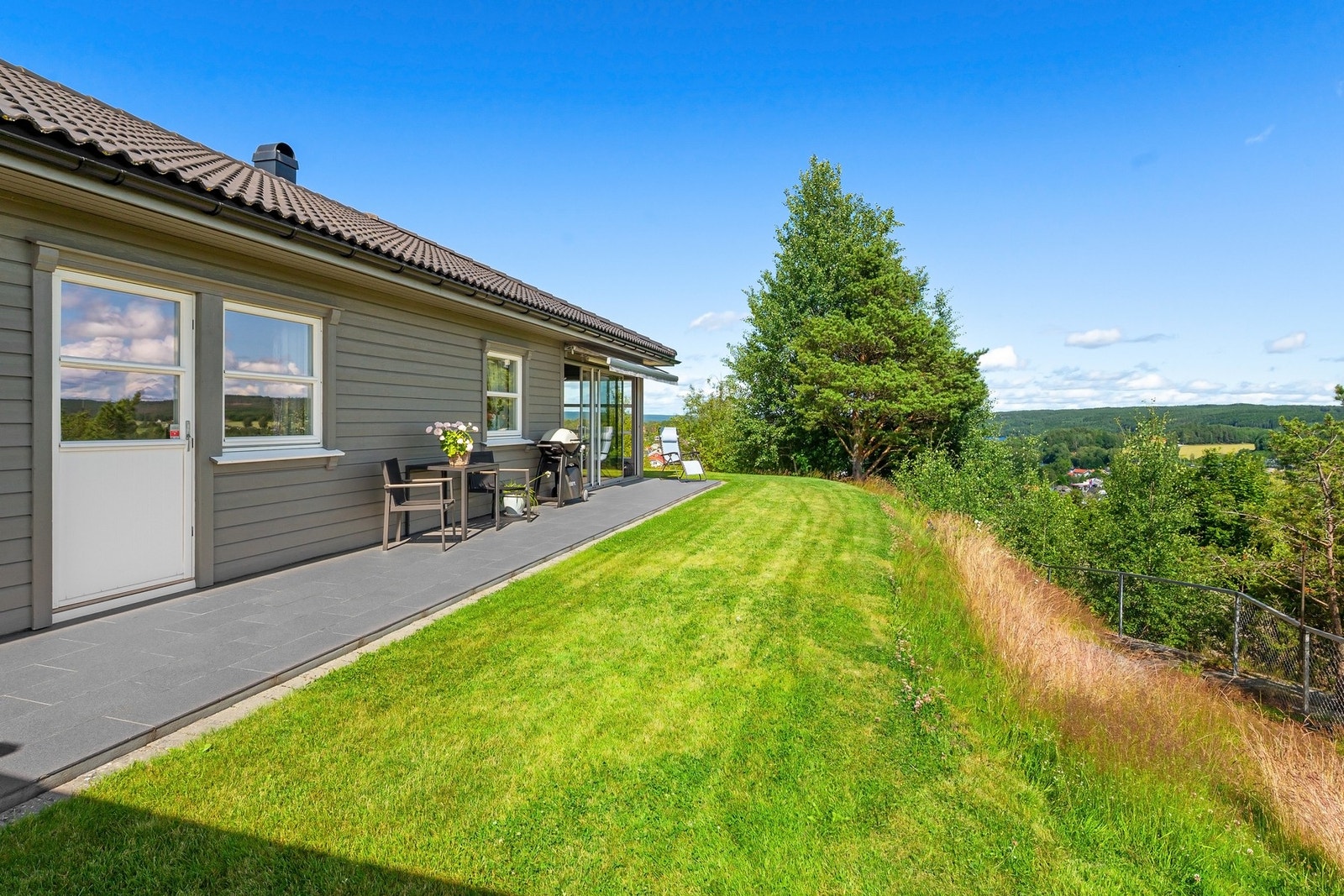 Hagen strekker seg på tre sider av boligen. Galleribilde