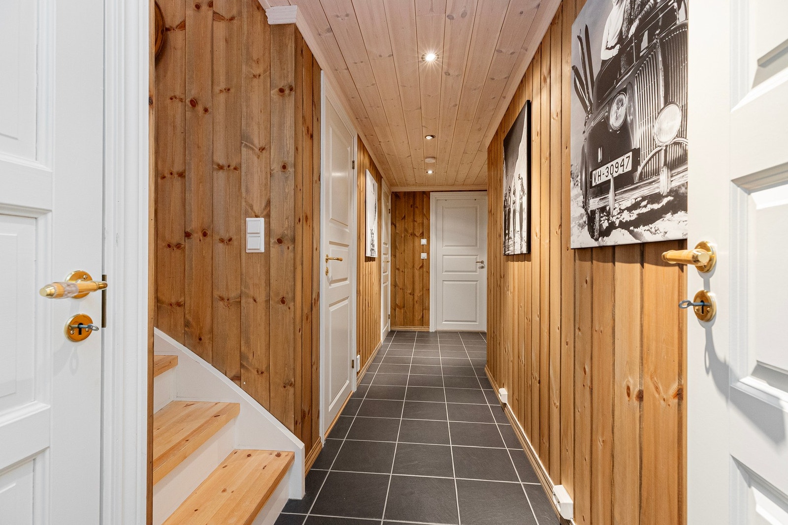 Fra flislagt gang i underetasjen. Her finner man tre soverom, et bad samt et dusjbad/vaskerom med dusjkabinett, servantskap og sluk (rommet er ikke godkjent som våtrom) Galleribilde