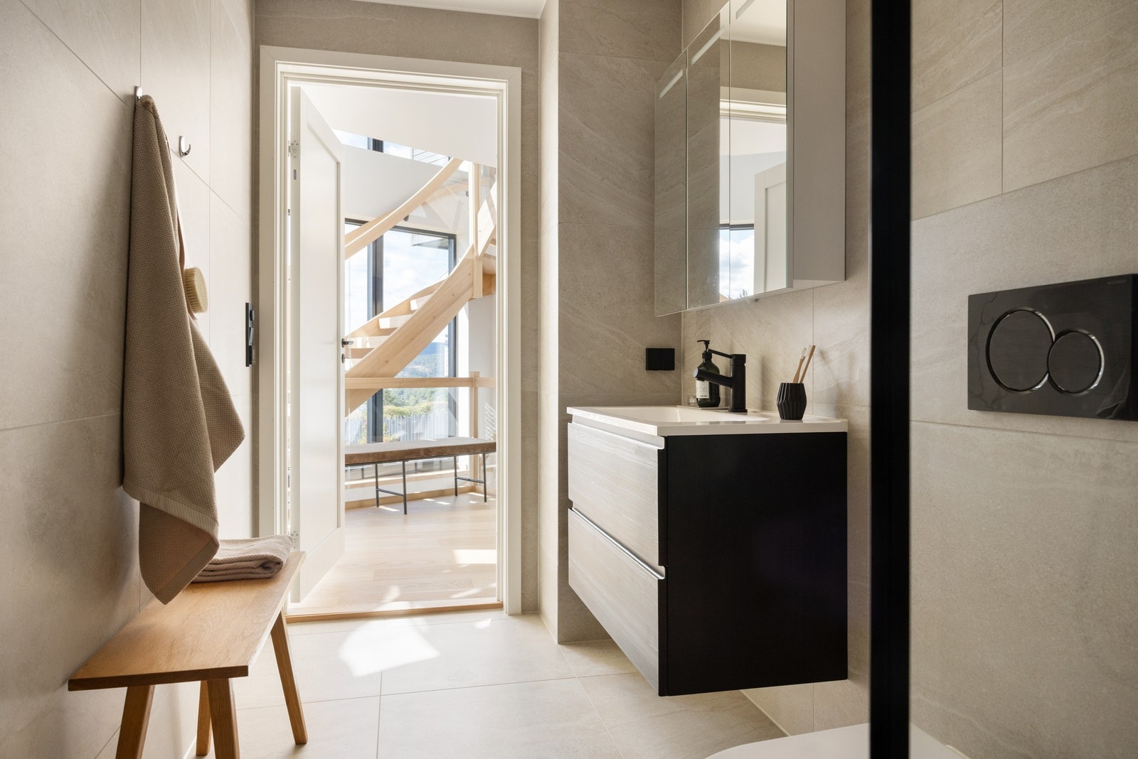 Bad 2 med servantinnredning, speilskap og lys inn fra hall. Galleribilde