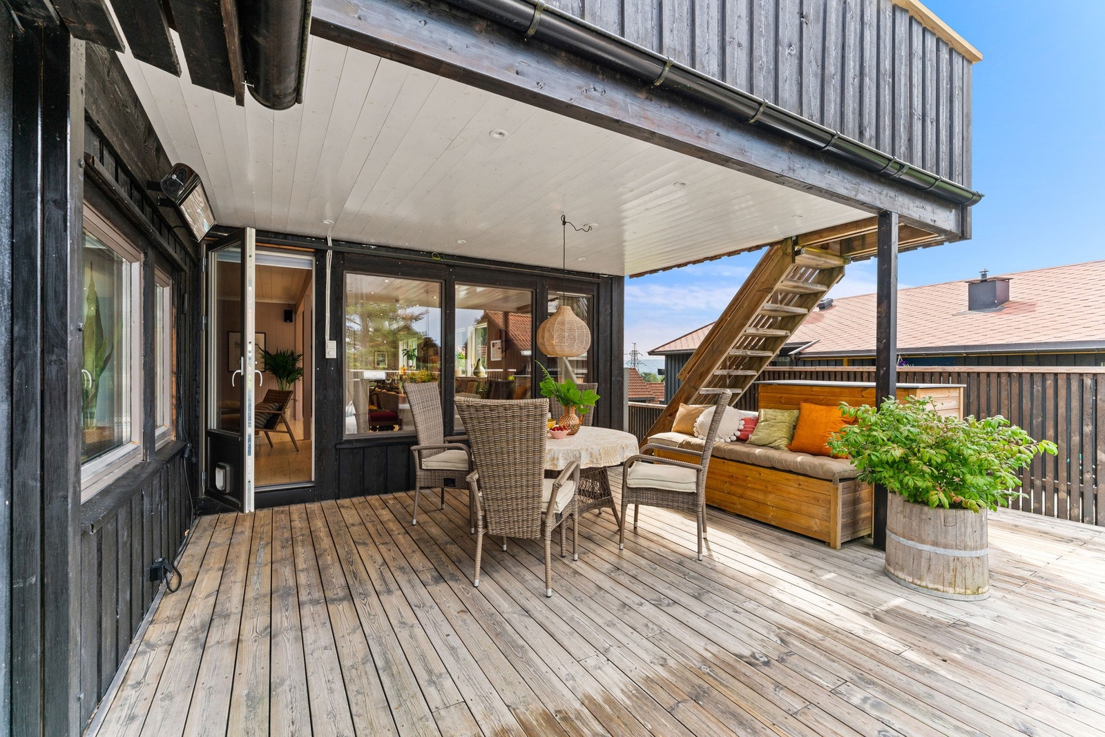 Fra stuen er det utgang til en stor og innbydende veranda som virkelig utgjør hjertet av boligens uteområde. Galleribilde