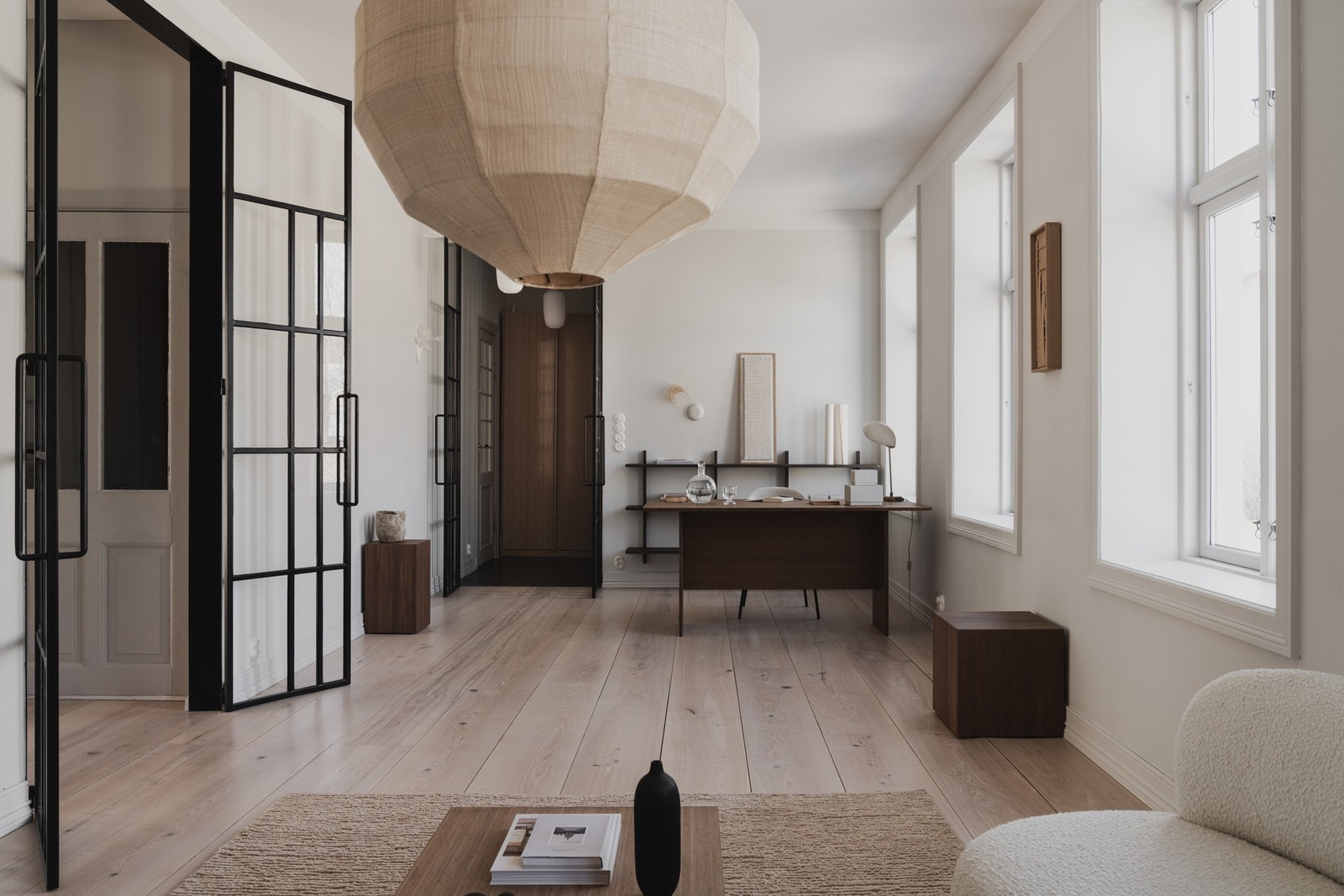 Tofløyede glassdører med omramming i smijern skiller stuen fra gangen mot badet og fra trapperommet mot spisestuen. Galleribilde