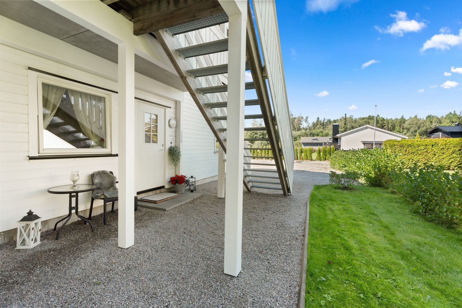 Utenfor inngangsdøren er det takoverbygg. Det er plass til parkering på grusplassen like ved inngangsdøren. Galleribilde