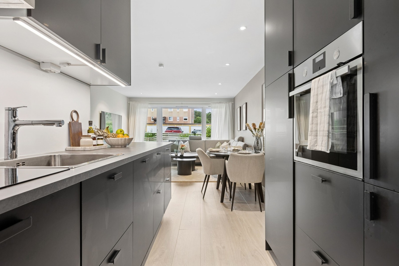 Lekker IKEA-kjøkken med mørk innredning og integrerte hvitevarer. Galleribilde