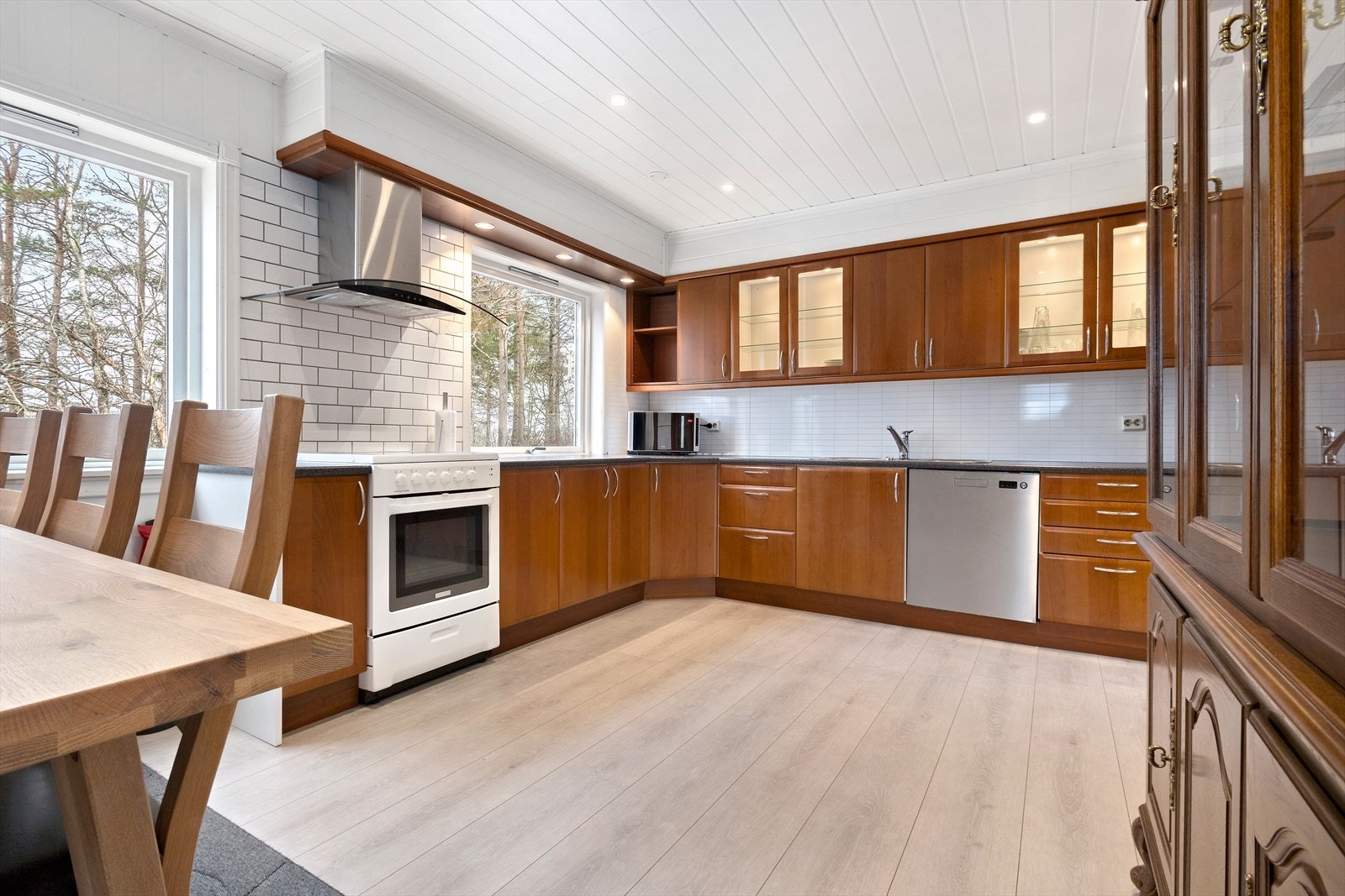 Stort kjøkken med fronter av heltre og benkeplate av laminat. Galleribilde