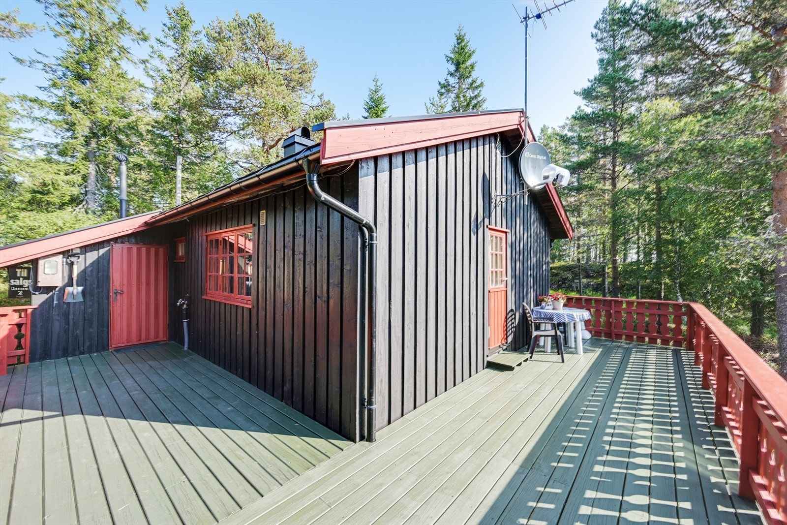 Hytta har en flott terrasse som strekker seg på to sider, på den ene siden finner vi hovedinngangen og den andre terrassedøren som leder inn til stuen Galleribilde
