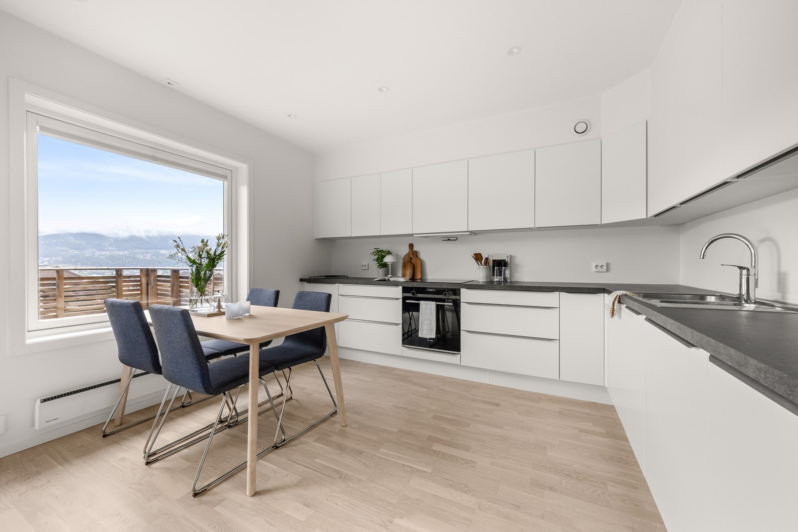 Innholdrik HTH kjøkkeninnredning bestående av over- og underskap samt store skuffer med glatte fronter og benkeplate i laminat Galleribilde