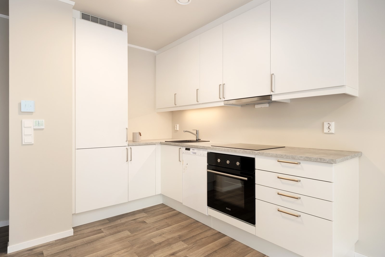 Kjøkkendelen er stilrein og har innreiing med kvite glatte frontar og benkeflate er av laminat. Kvitevarer er innebygd. Galleribilde