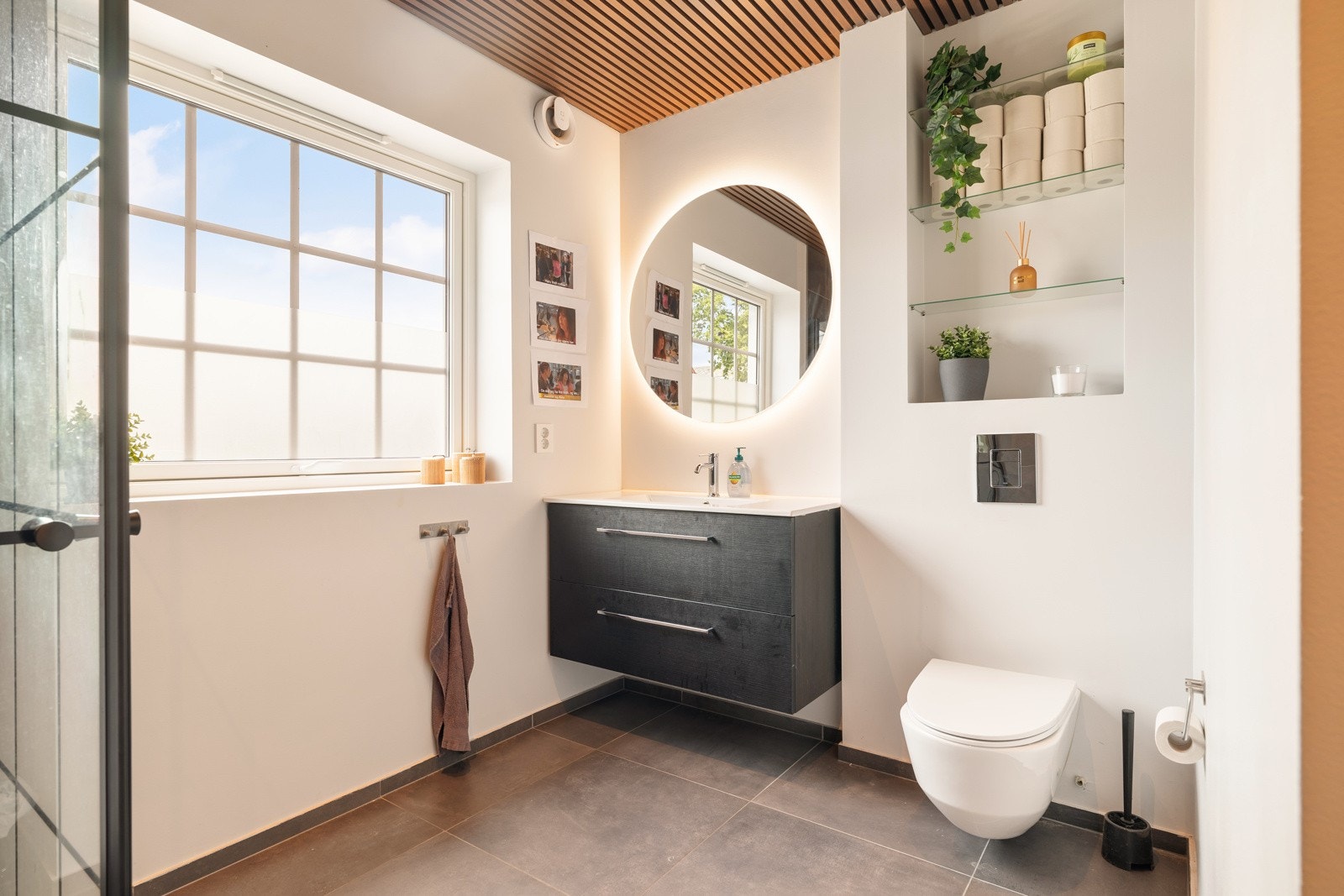 Moderne bad fra 2022-2023 på romslige 6,5 kvm. Utstyrt med pent servantskap, veggmontert toalett, og speil med belysning. Galleribilde