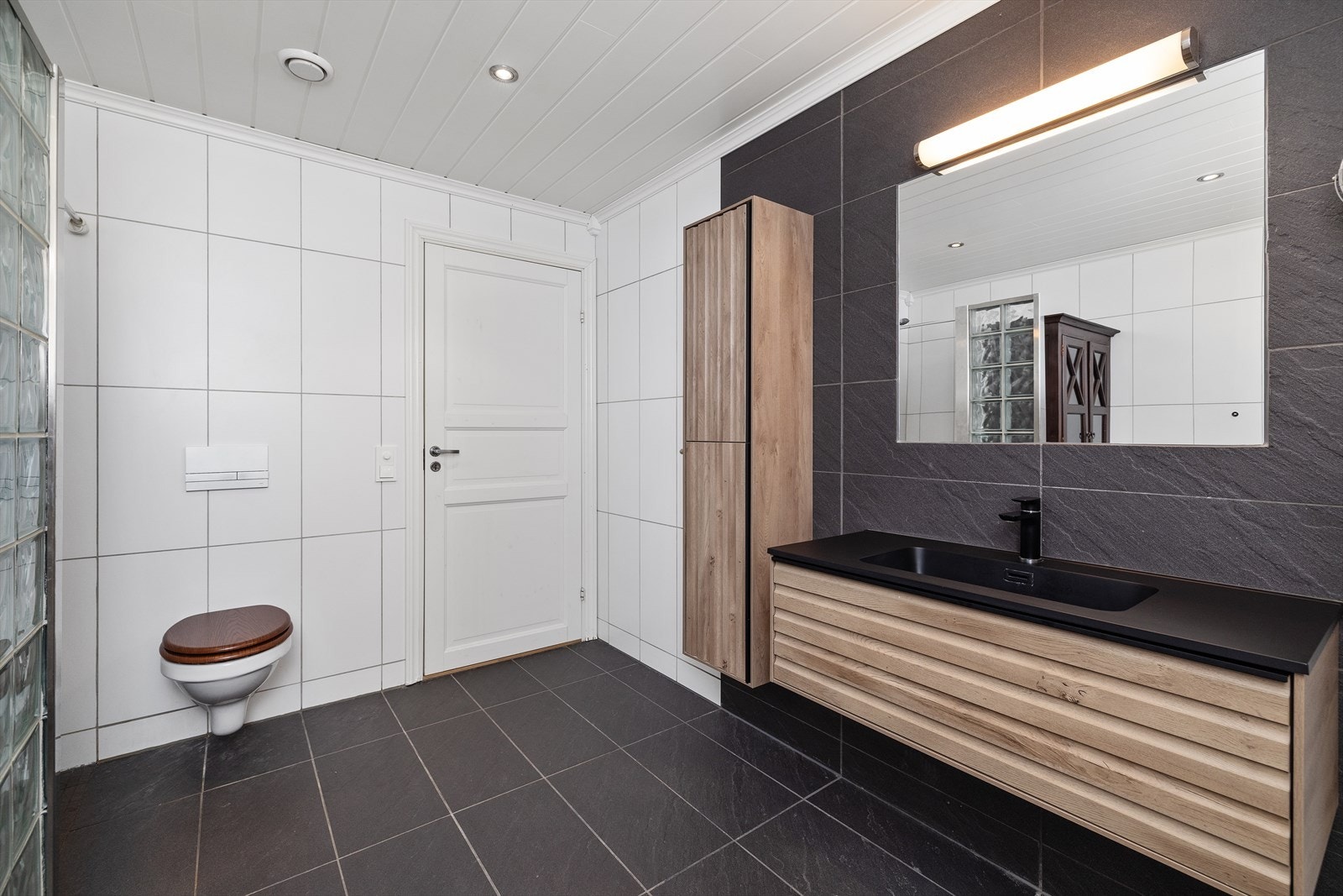 I underetasjen finner man et lyst flislagt bad med elektriske varmekabler i gulvet. Galleribilde