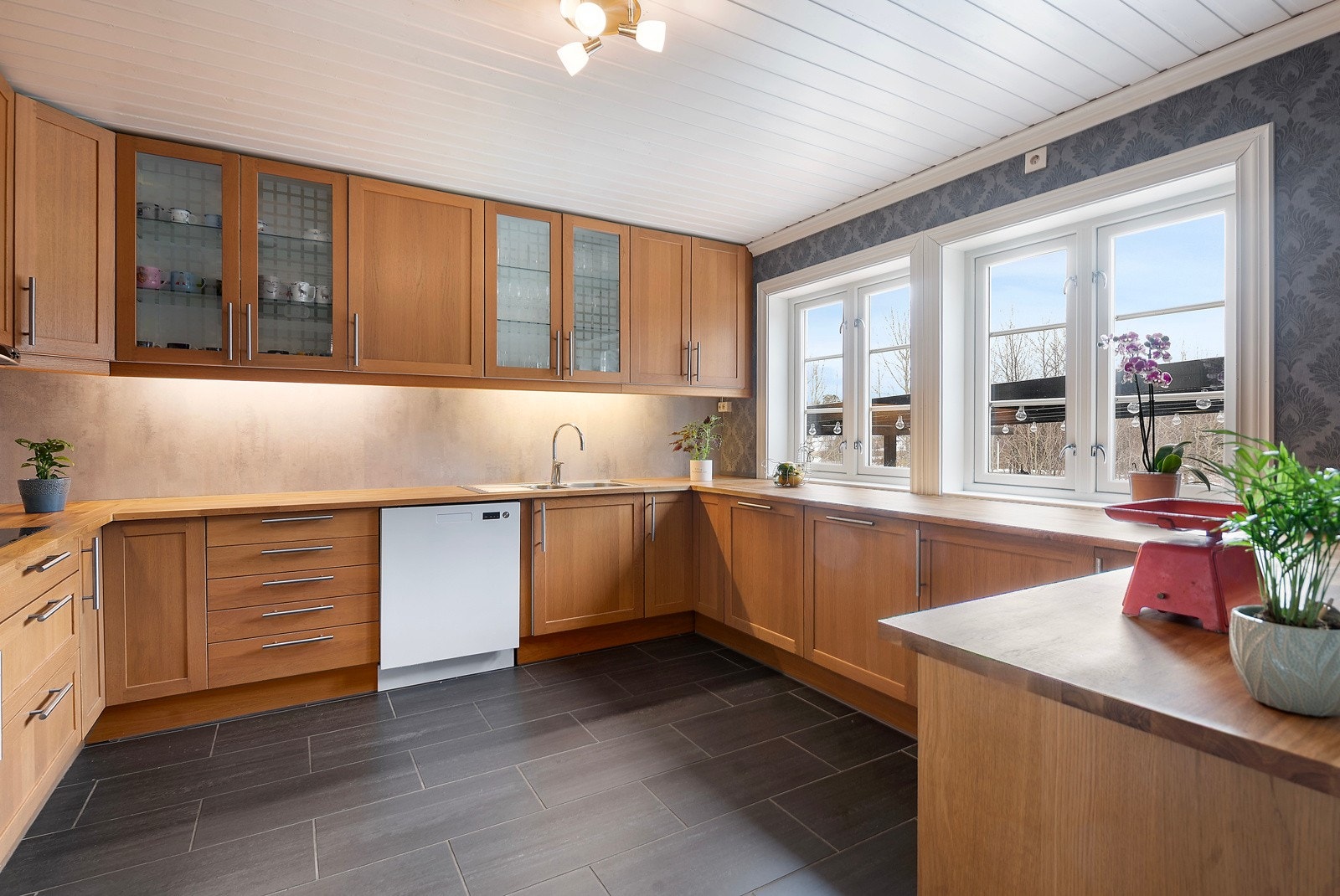 Med kjøkkenbenk og innredning langs alle vegger er dette et kjøkken hvor kokken har god plass til å utfolde seg Galleribilde