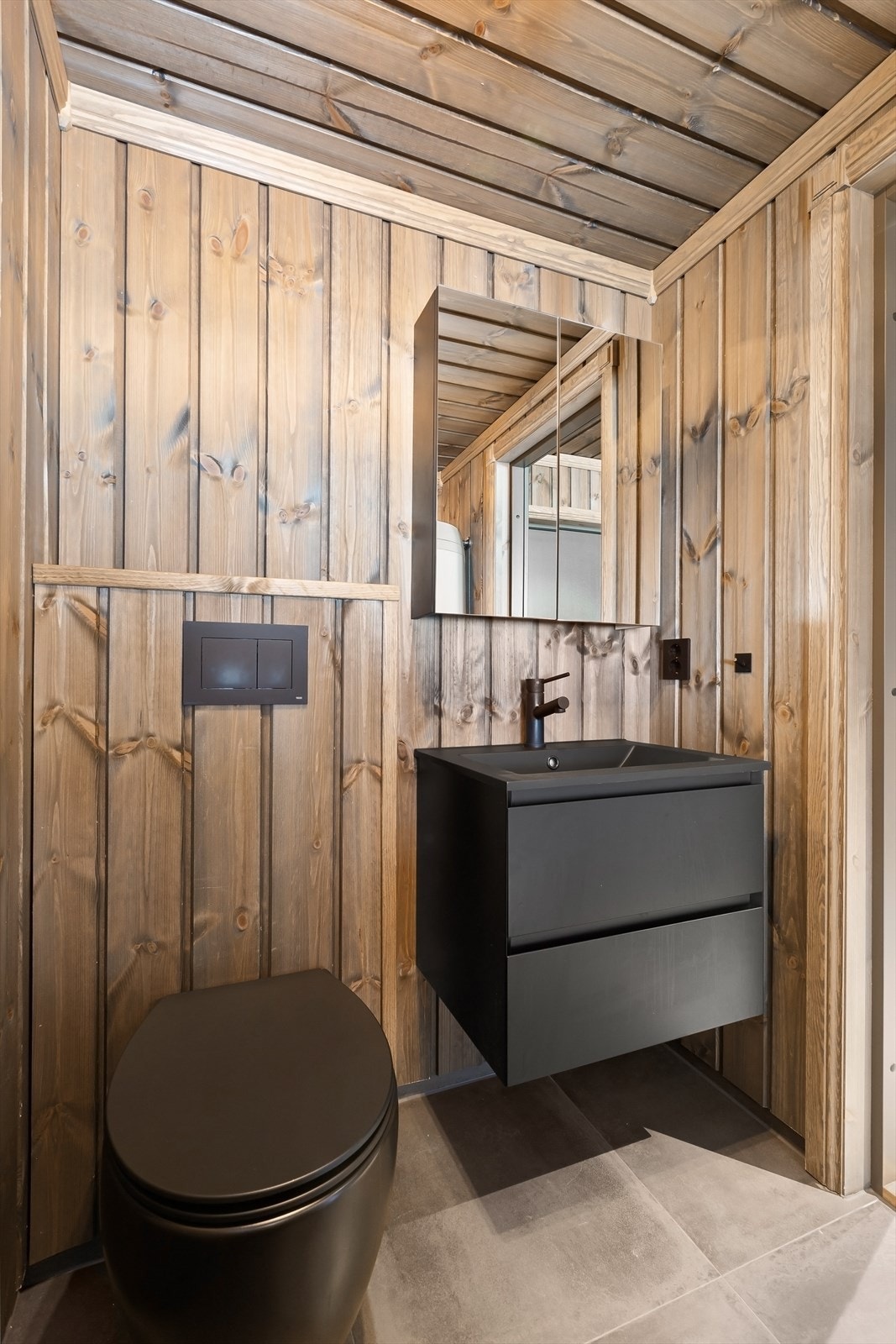 Stilrent gjestetoalett i lune materialer, også med tilgang fra entrê Galleribilde