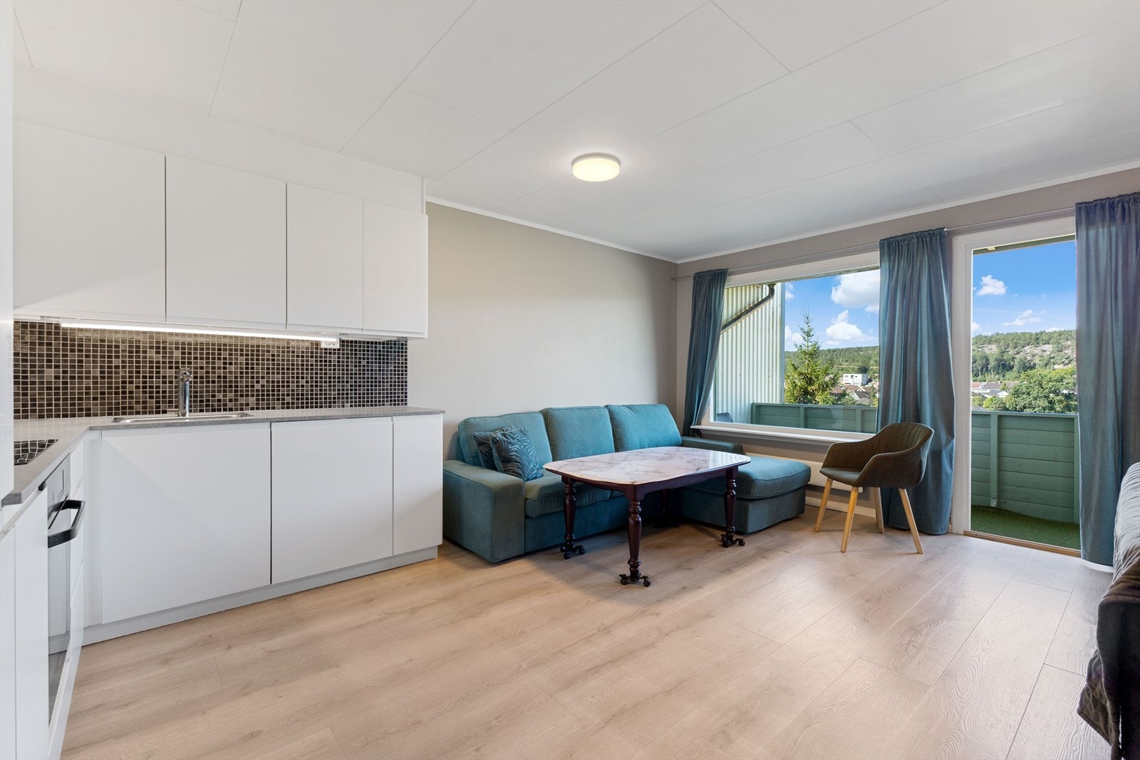 Fra entréen, med plass til oppbevaringsmøbel for yttertøy og sko, kommer du inn i en lys og pen stue. Galleribilde