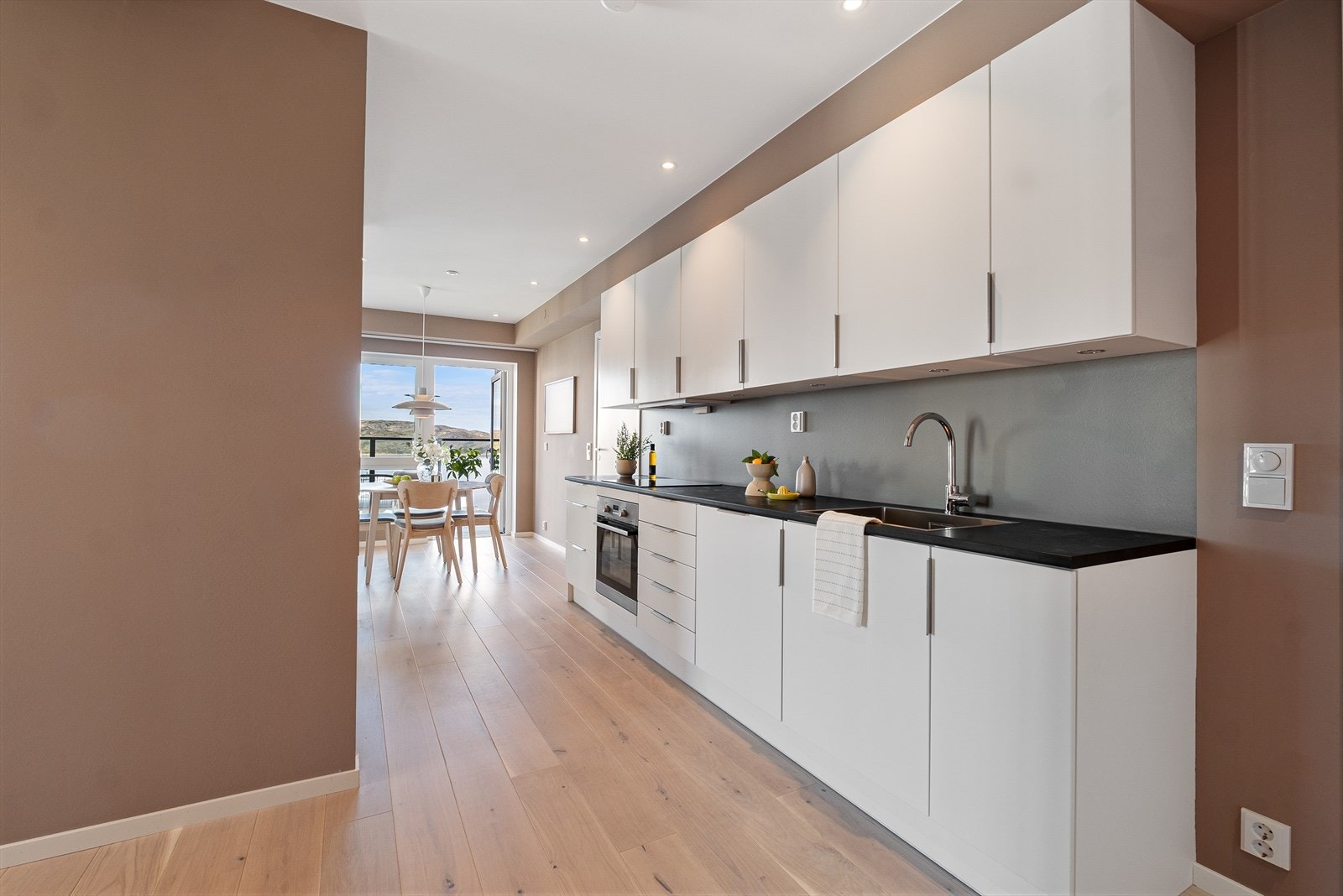 Stilfull kjøkkeninnredning fra Arens med hvite glatte kjøkkenfronter. Galleribilde