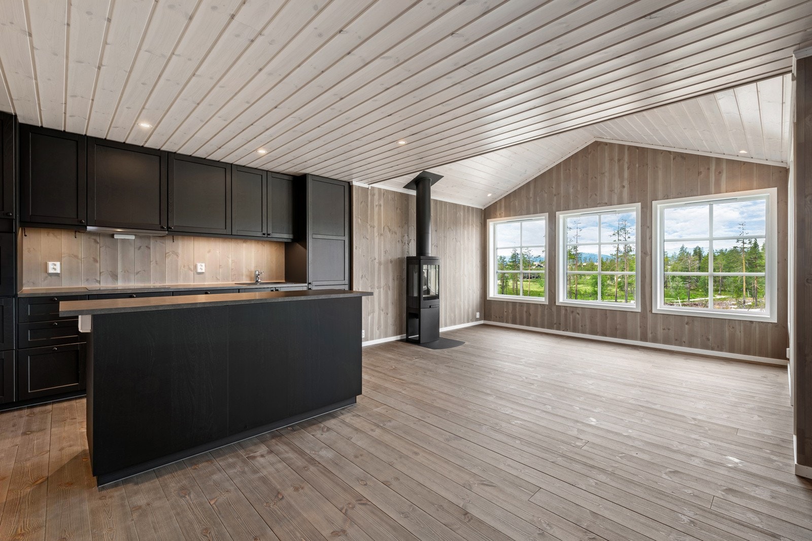 Melllom stue og kjøkken er det en koselig peis som gir rikelig med varme og hygge. Galleribilde