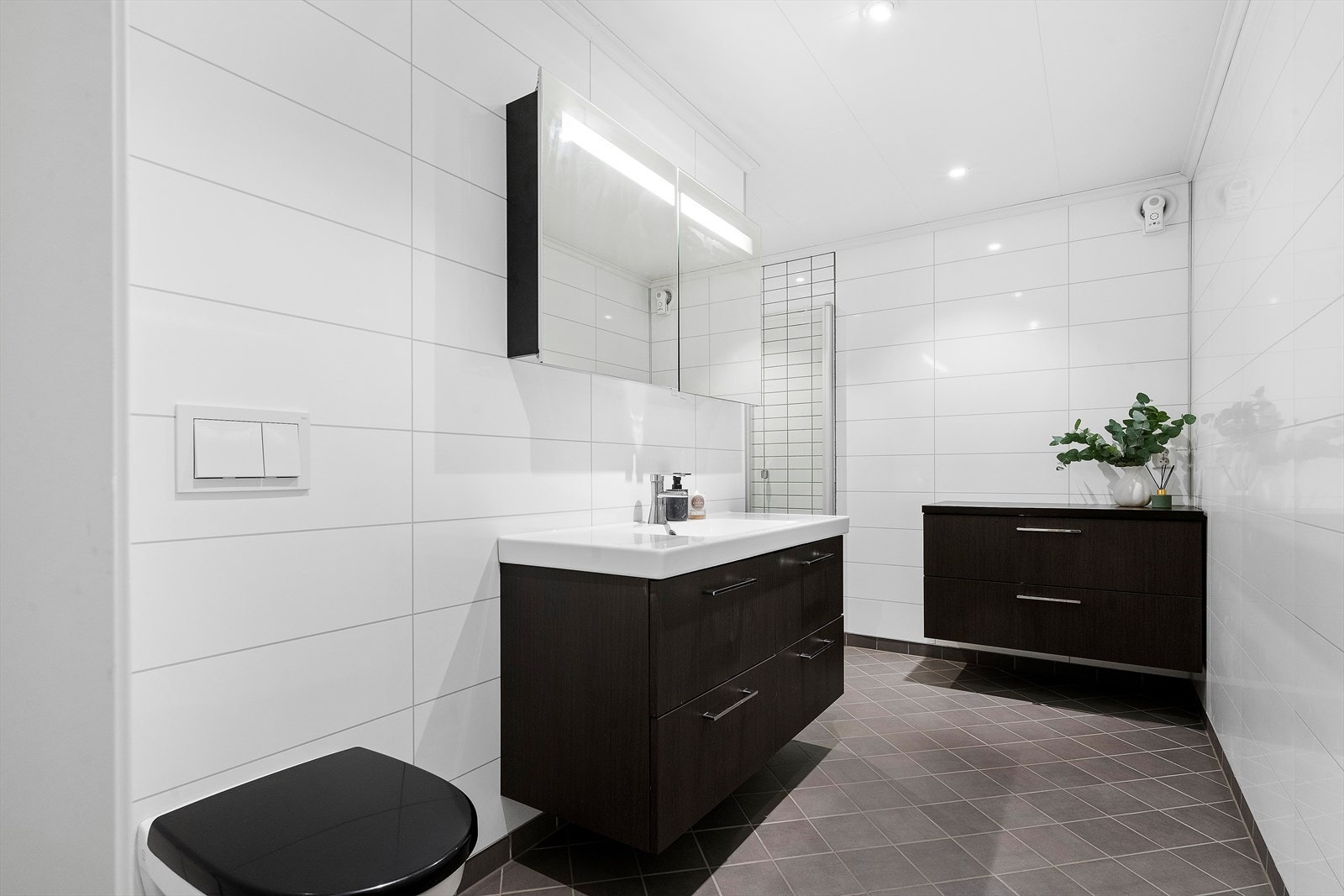 Badet er fra 2014 og er innredet med vegghengt toalett, innredning med servant og dusjnisje. Galleribilde