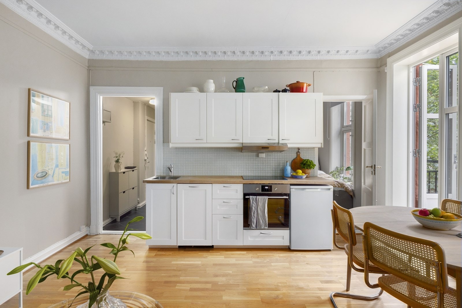 Kjøkkenet ligger i en åpen løsning mot stuen og oppleves som delikat med god skap og benkeplass. Galleribilde