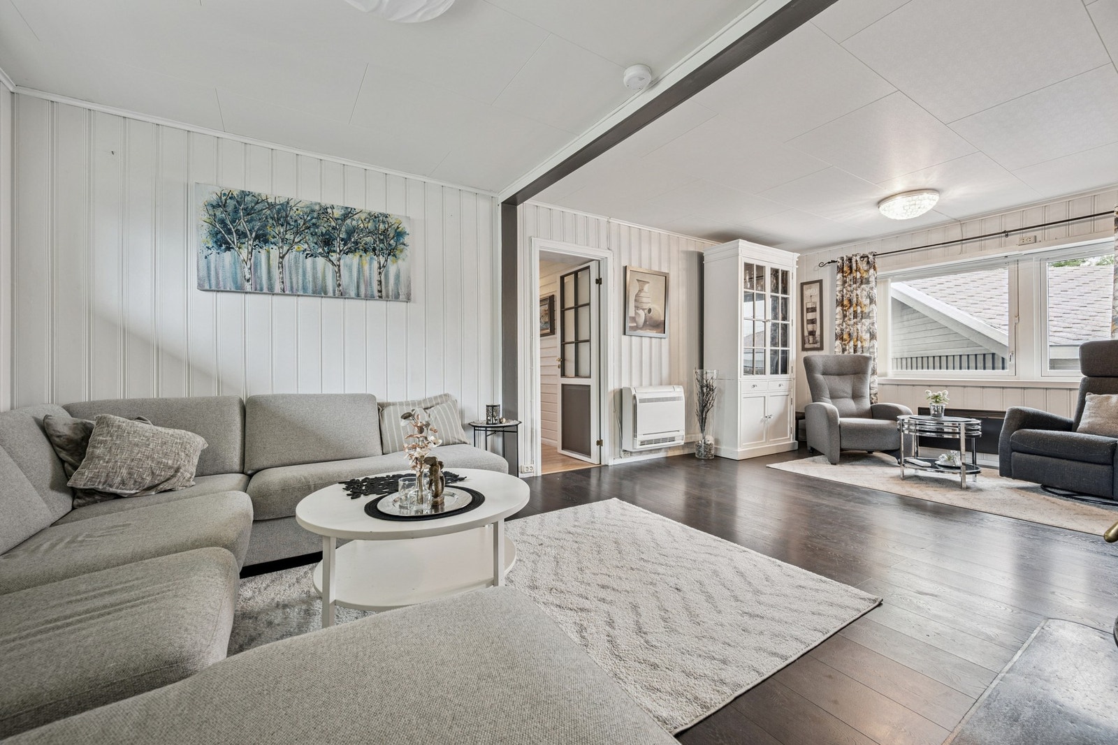 Velkommen til Øyjordveien 9. Stuen gir deg muligheten til å innrede med flere soner - perfekt for både hverdag og selskap. Det er montert varmepumpe i stuen. Foto: EFKT. Galleribilde