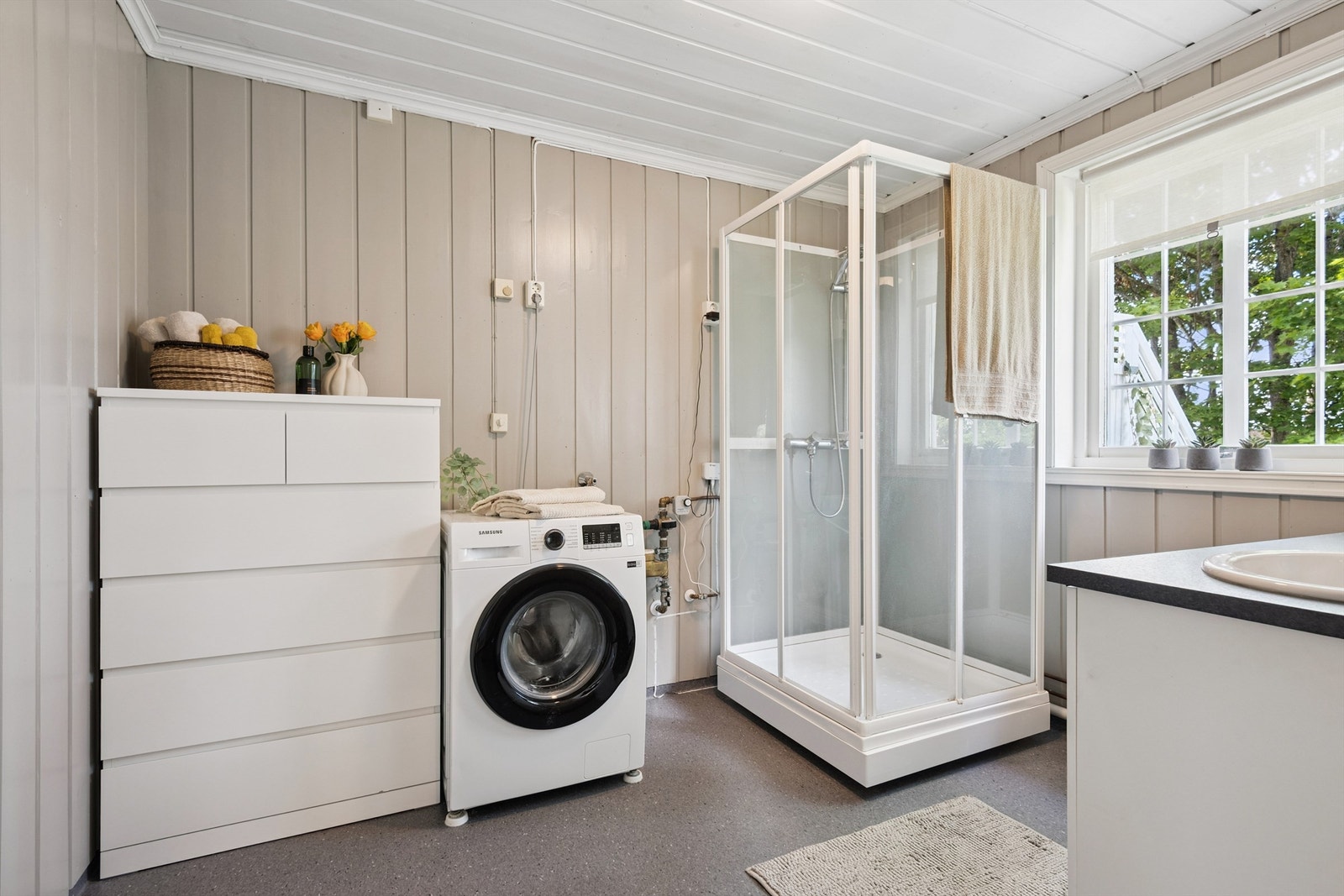 Badet har god plass til ekstra oppbevaring i tillegg til vaskemaskin. Det er ikke sluk i gulvet. Galleribilde