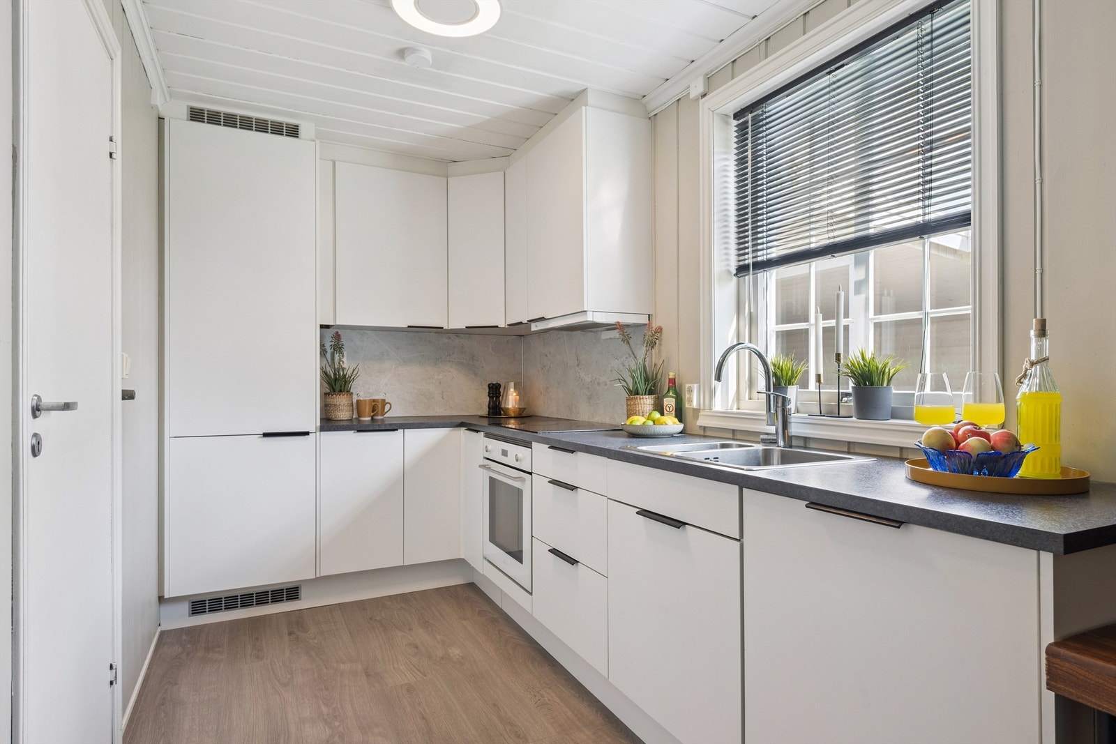 Kjøkkeninnredning med glatte fronter og godt med skapplass. Galleribilde