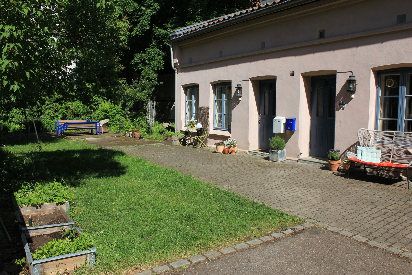 Frodig bakgård med felles epletrær, solbærbusk, blåbær og stikkelsbær. Galleribilde