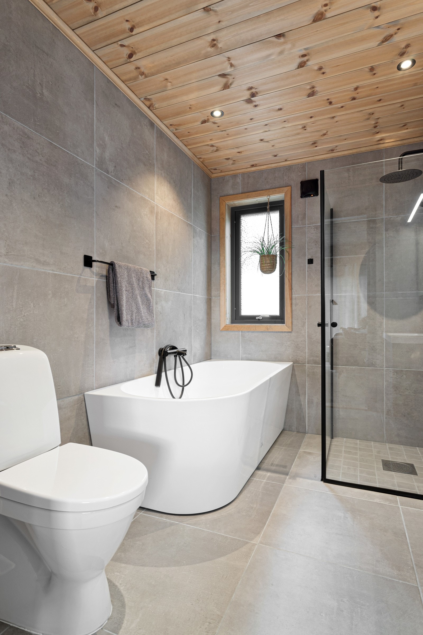 Badet inneholder servant i innredning, speilskap, badekar, dusjnisje med regnfall-armatur og toalett Galleribilde