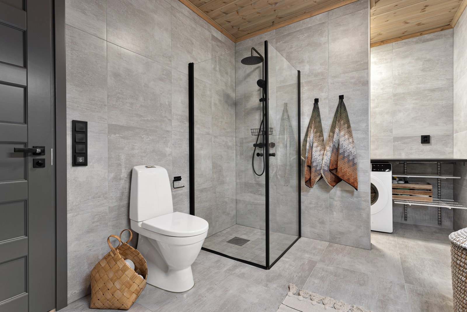 Badet inneholder innredning med servant, dusjnisje med glassvegger og waterfall armatur og toalett Galleribilde