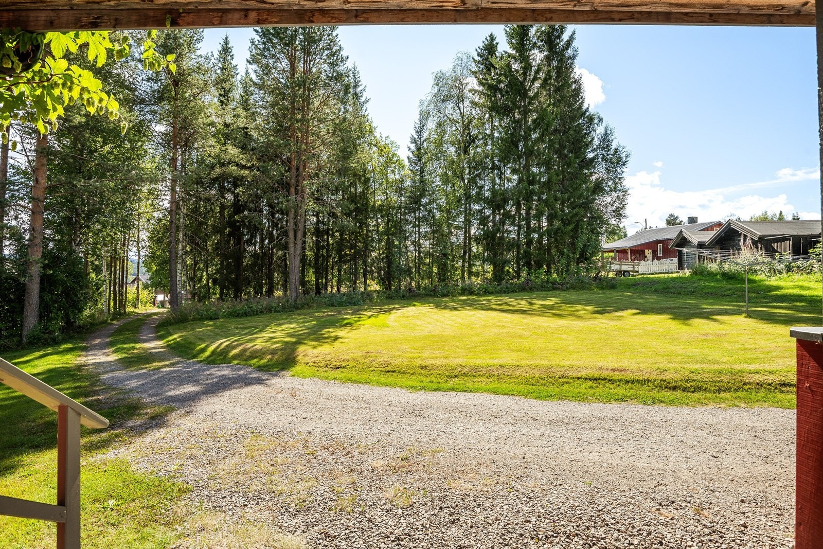 Flat, solrik og skjermet tomt. Opparbeidet med plen og allé opp mot huset. Variert beplantning, stauder og bed. Gruset innkjøring og parkering. Delvis naturtomt. Galleribilde